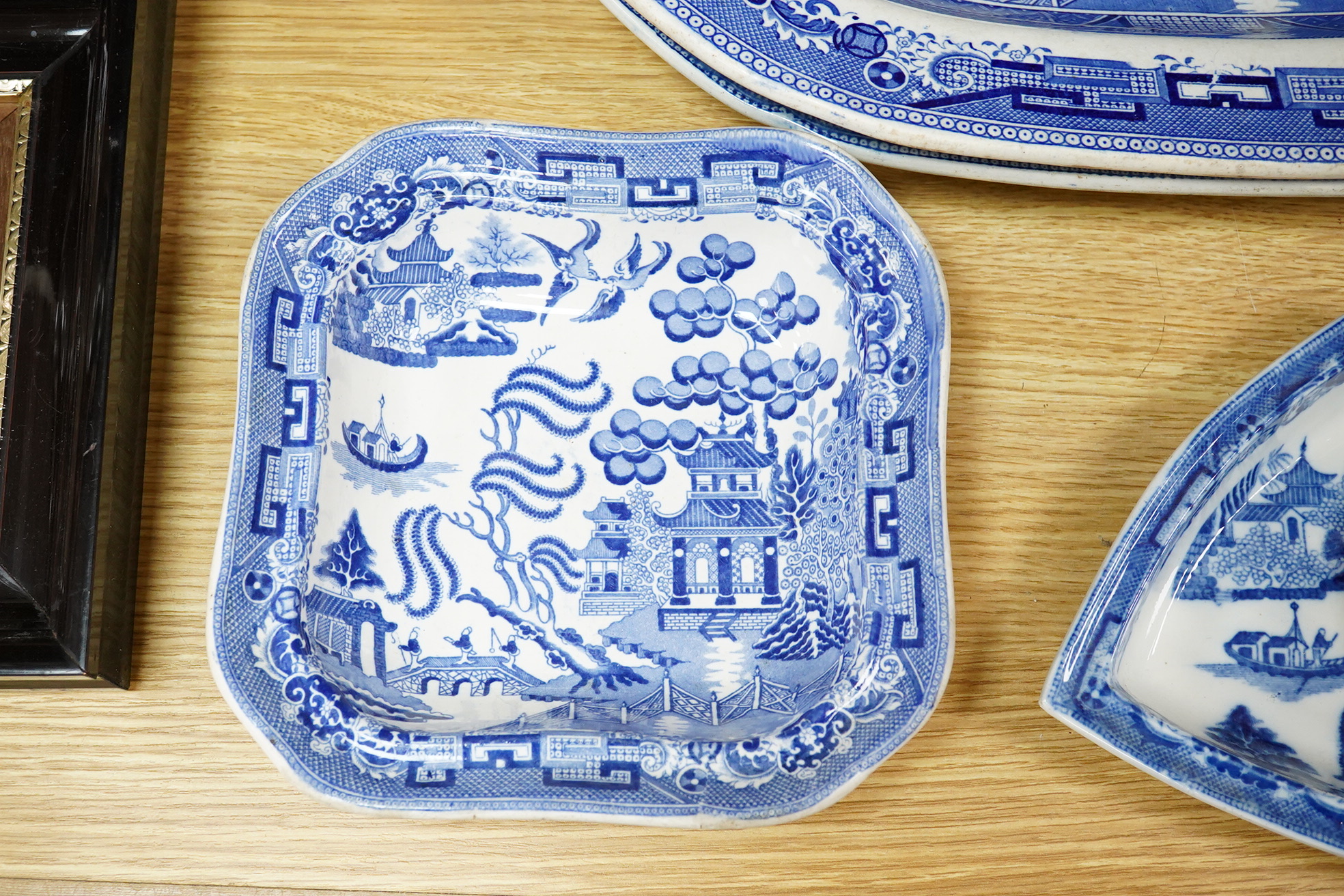 A quantity of Victorian blue and white pottery and a large Worcester jug, meat platters 45cm wide